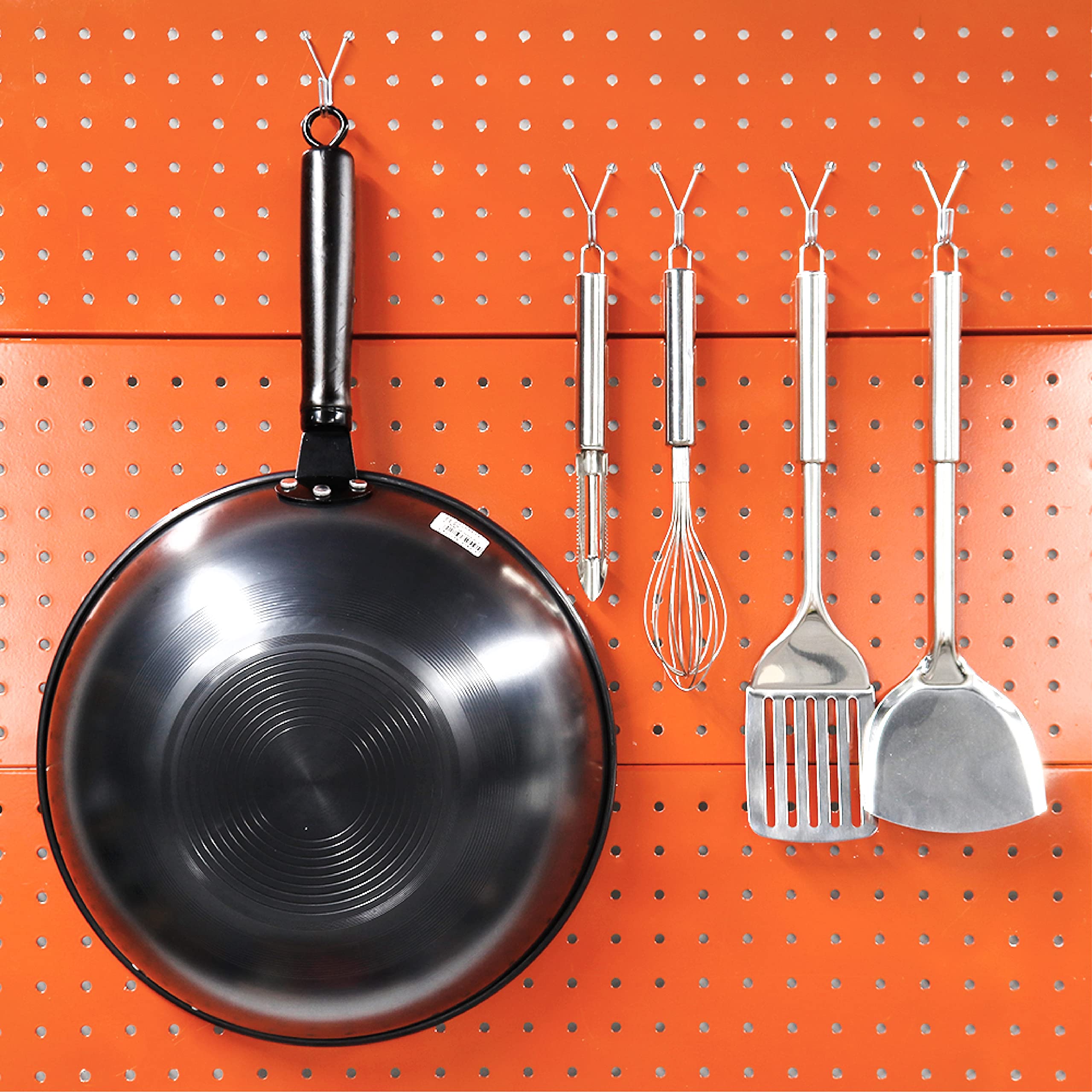 This image shows a pegboard system used to organize and display various kitchen utensils and cookware. 