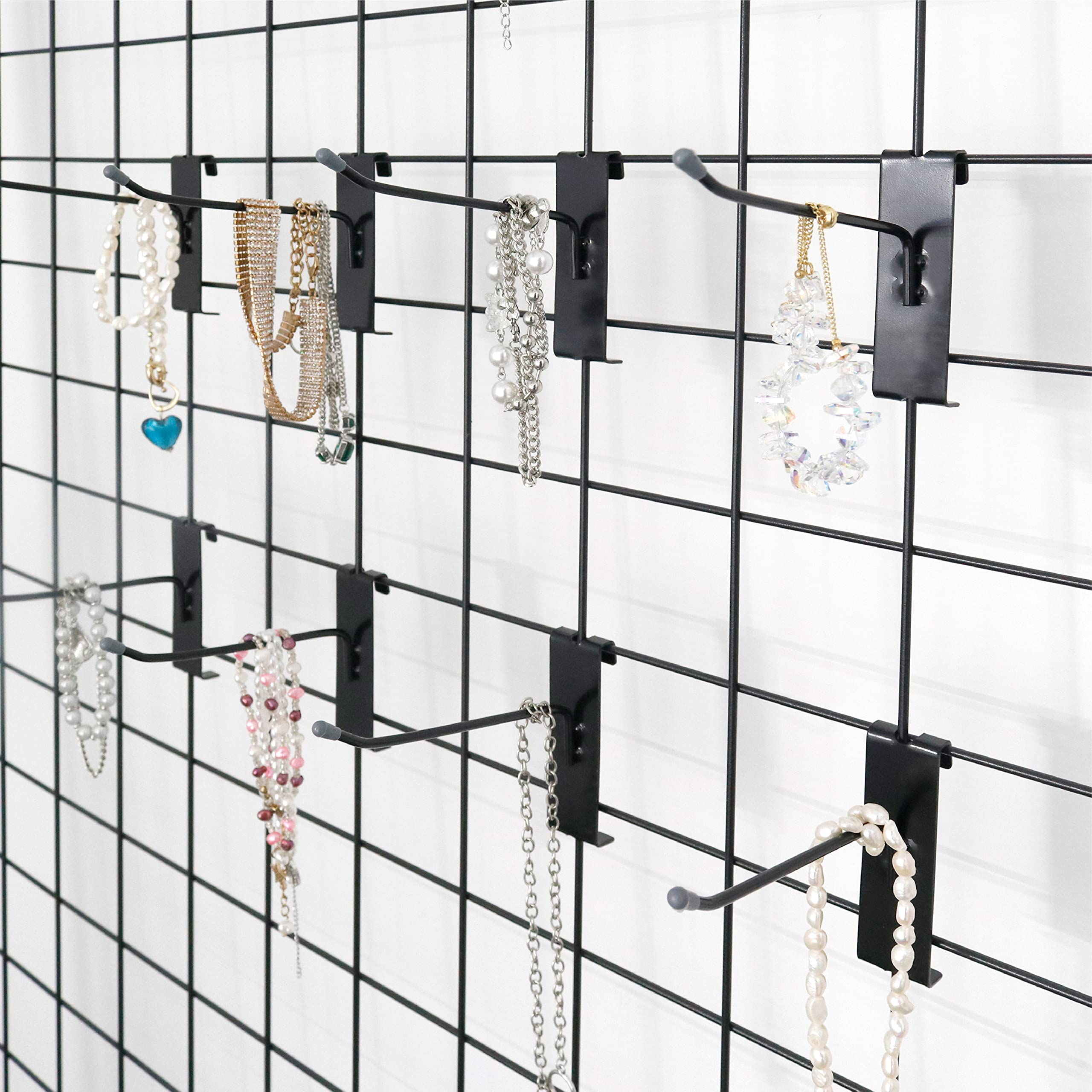 This image shows a metal grid display rack used to showcase various jewelry pieces, particularly necklaces.